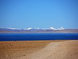 06 Lake Manasarovar And Peaks Of Indian Himalaya From First View Of Mount Kailash The Indian Himalaya stands above the blue waters of Lake Manasarovar seen from the crest of the small hill that has the first view of Mount Kailash.